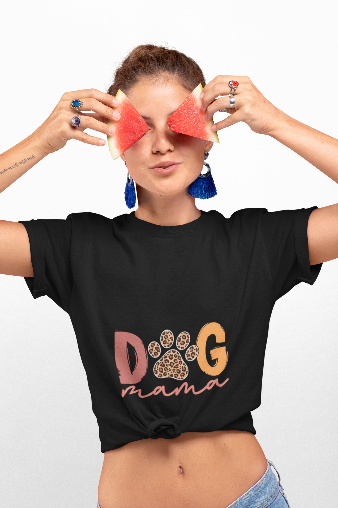 Woman wearing Printify black Dog Mama Tee with leopard paw design knotted front holding watermelon slices