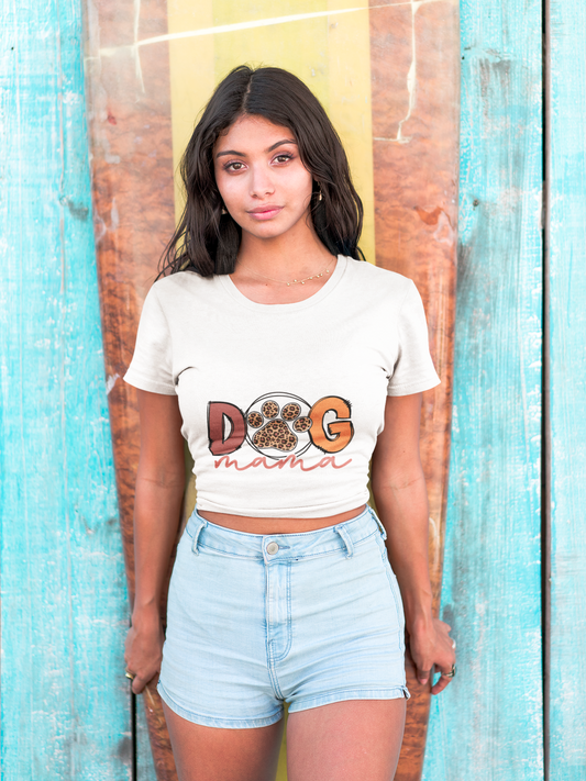 Model wearing Printify Dog Mama Tee white cropped t shirt with paw print design and denim shorts