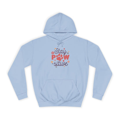 Light blue Printify Stay Pawsitive Unisex Hoodie with colorful paw print graphic and kangaroo pocket