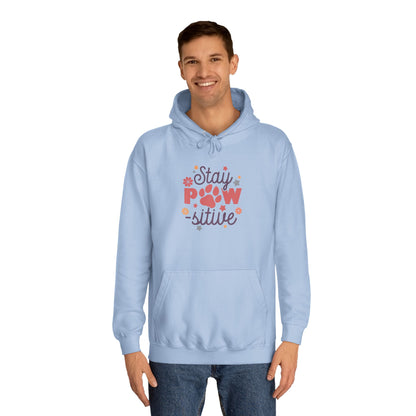 Stay Pawsitive Unisex Hoodie light blue pullover on male model with paw print graphic and kangaroo pocket