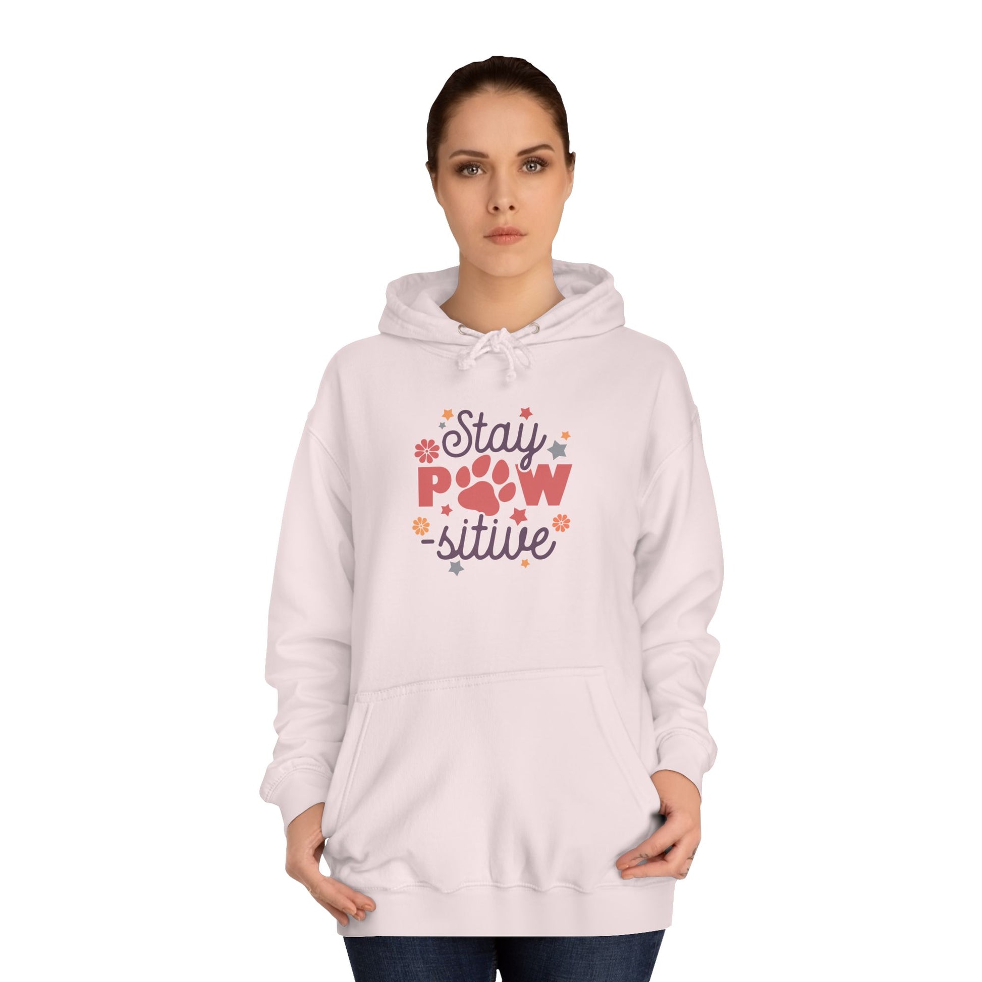 Stay Pawsitive Unisex Hoodie on female model wearing light pink hoodie with paw graphic and floral accents