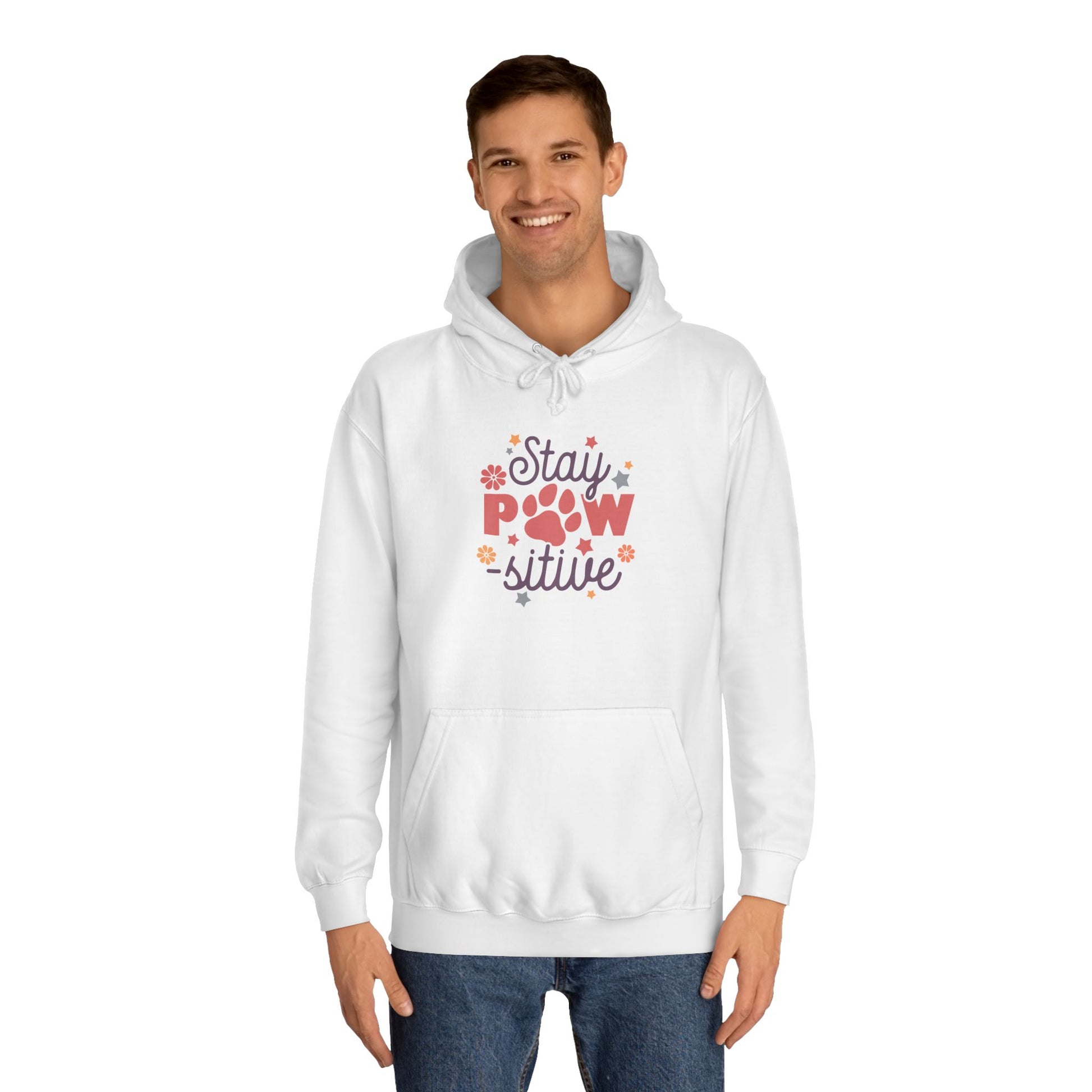 Stay Pawsitive Unisex Hoodie white pullover on smiling male model with paw graphic and floral accents and kangaroo pocket