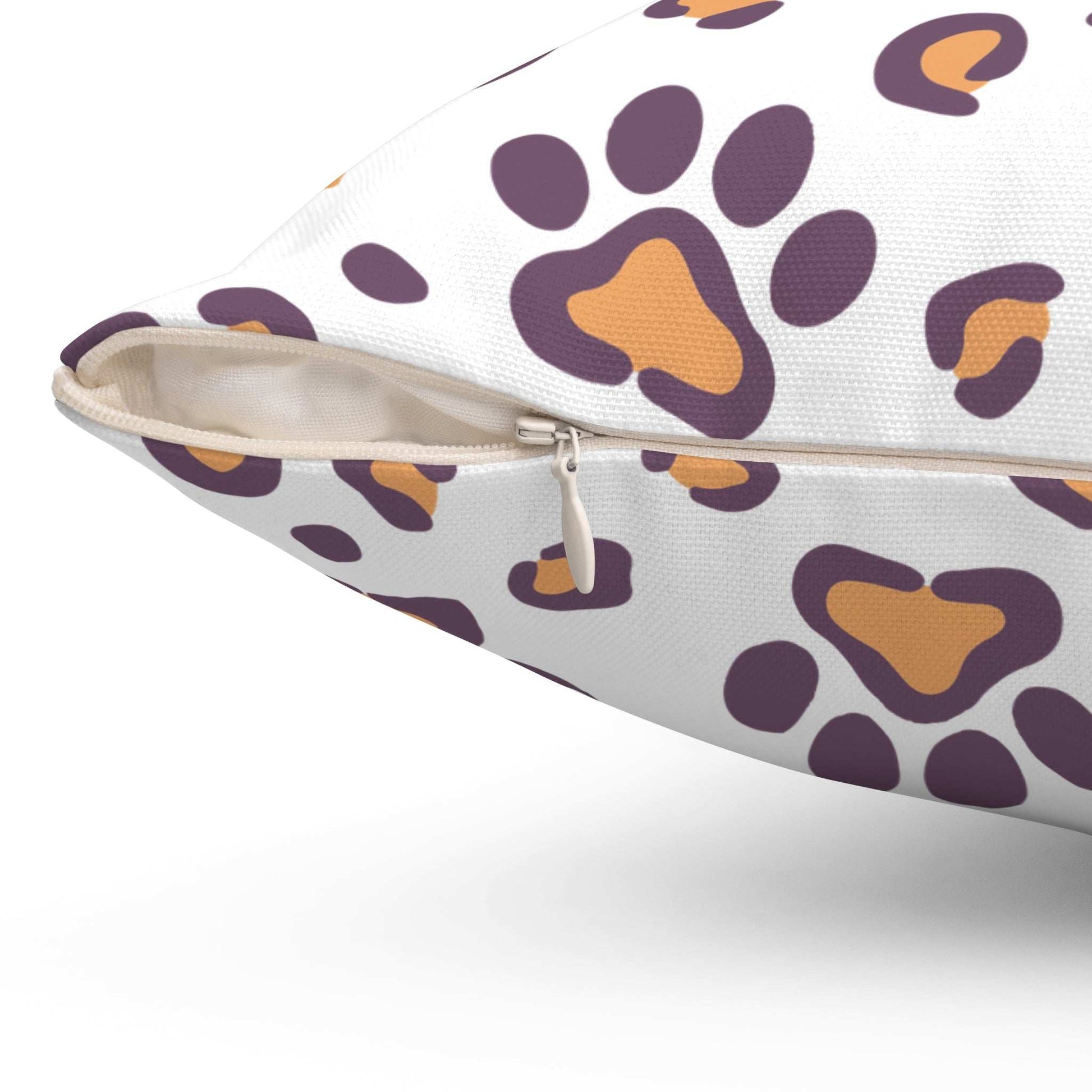 Dog Lovers Pillow close up showing white zippered cover with purple and orange paw print pattern