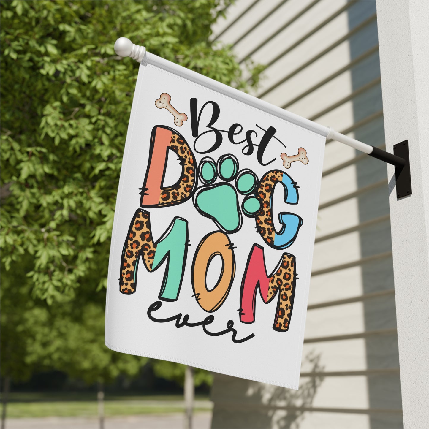 Dog Mom Garden Flag by Printify white porch flag reading Best Dog Mom ever with colorful letters paw print leopard spots and bones