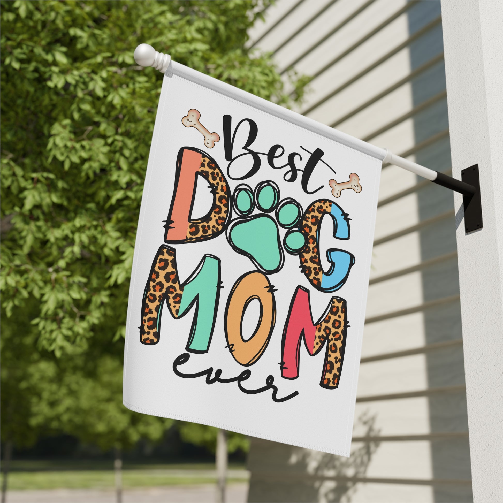 Dog Mom Garden Flag by Printify white porch flag reading Best Dog Mom ever with colorful letters paw print leopard spots and bones