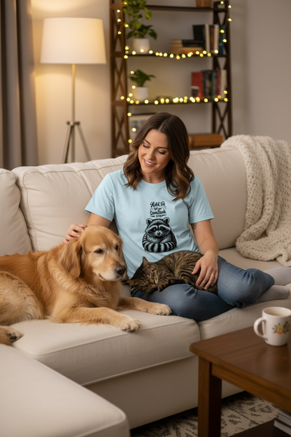 Person wearing Overthinking Racoon t-shirt relaxing on couch with pet