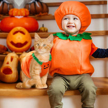 Cute child and cat in matching Pet Dog Costume pumpkin outfits for Halloween celebrations