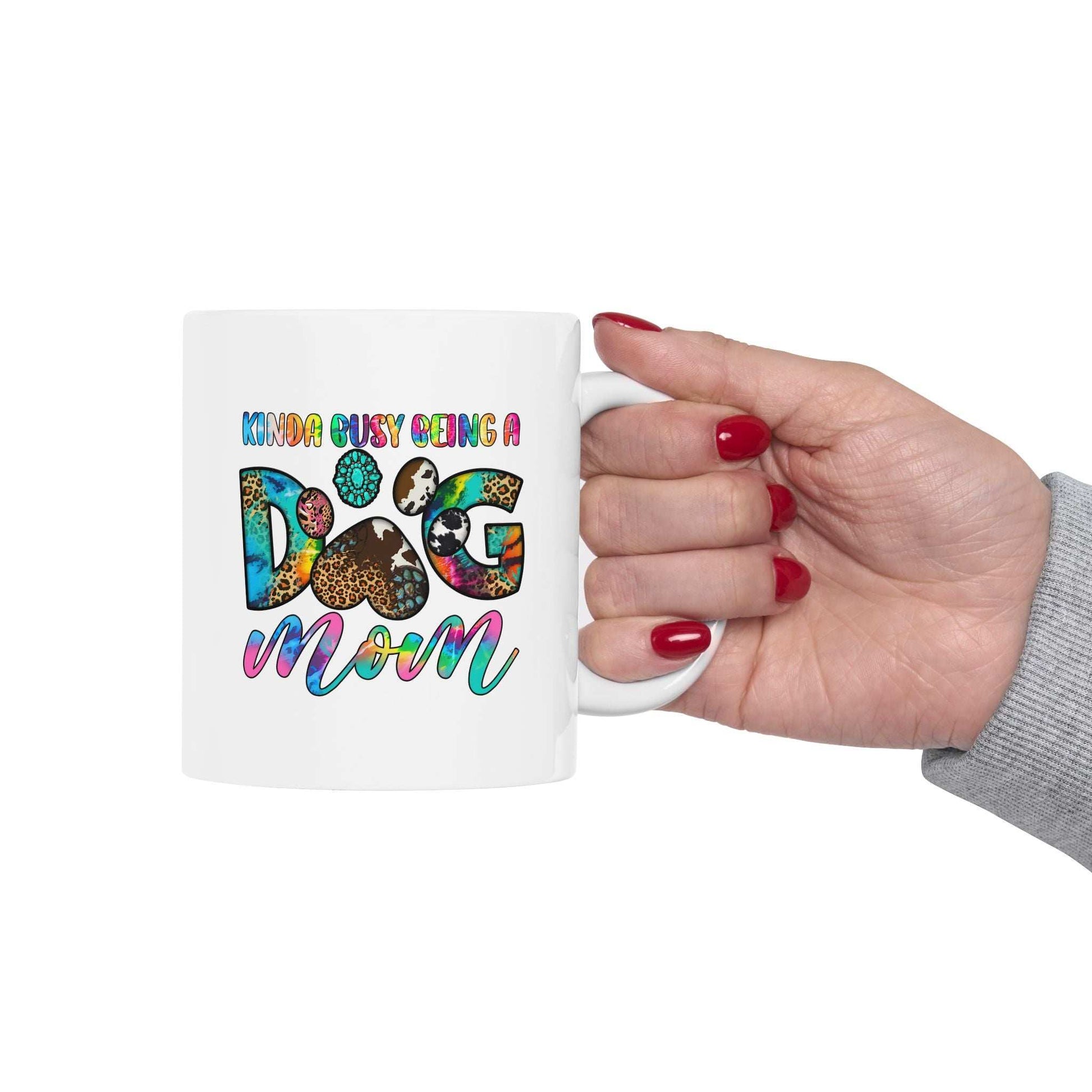 Printify white ceramic mug with colorful Kinda Busy Being a Dog Mom design held in hand Pet Owner Coffee Cup