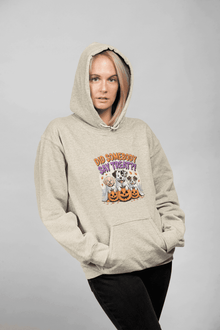 Woman modeling Printify beige hoodie featuring three dogs with pumpkins graphic titled Halloween Dog Sweatshirt