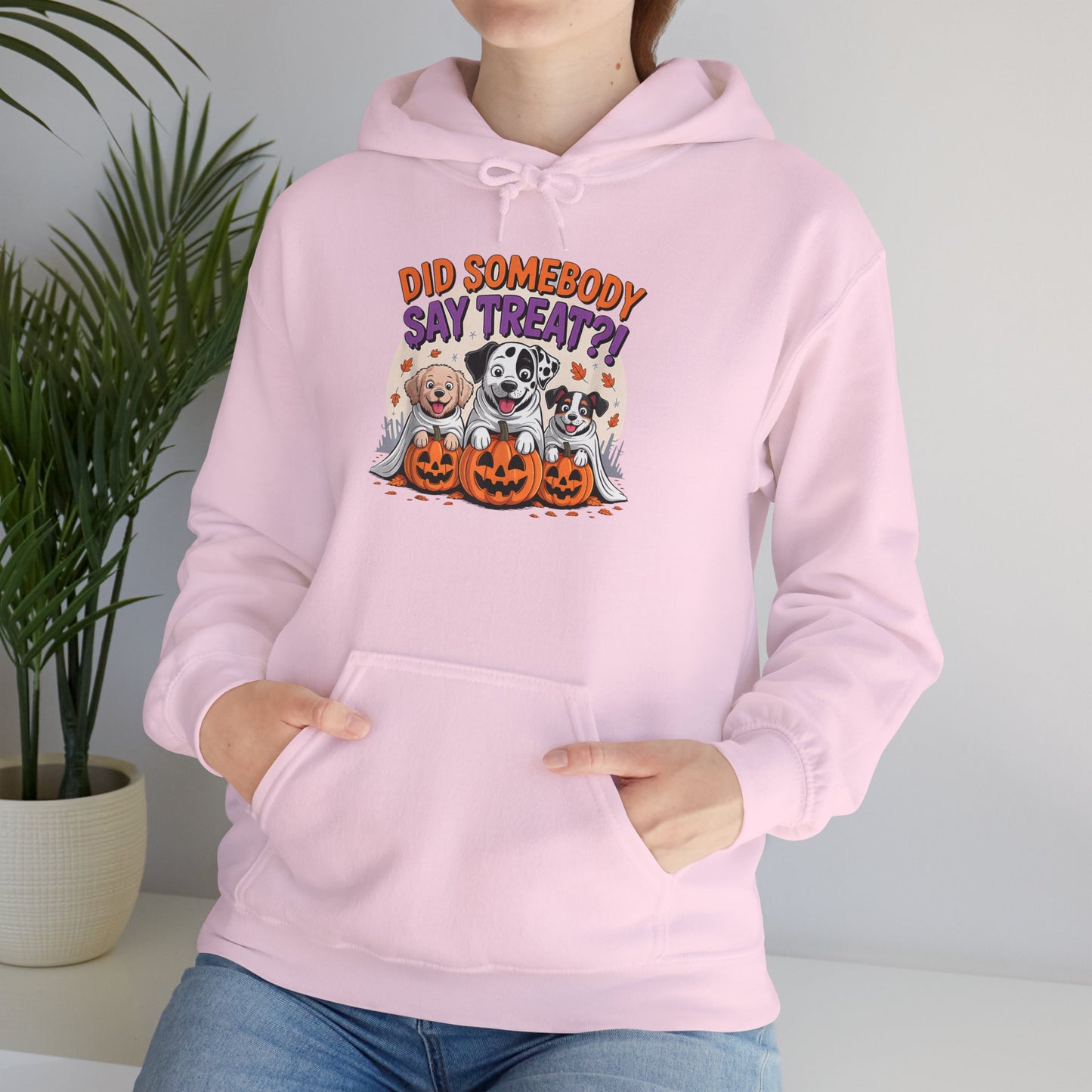 Printify pink hoodie featuring Halloween Dog Sweatshirt design with three dogs, pumpkins and Did Somebody Say Treat text