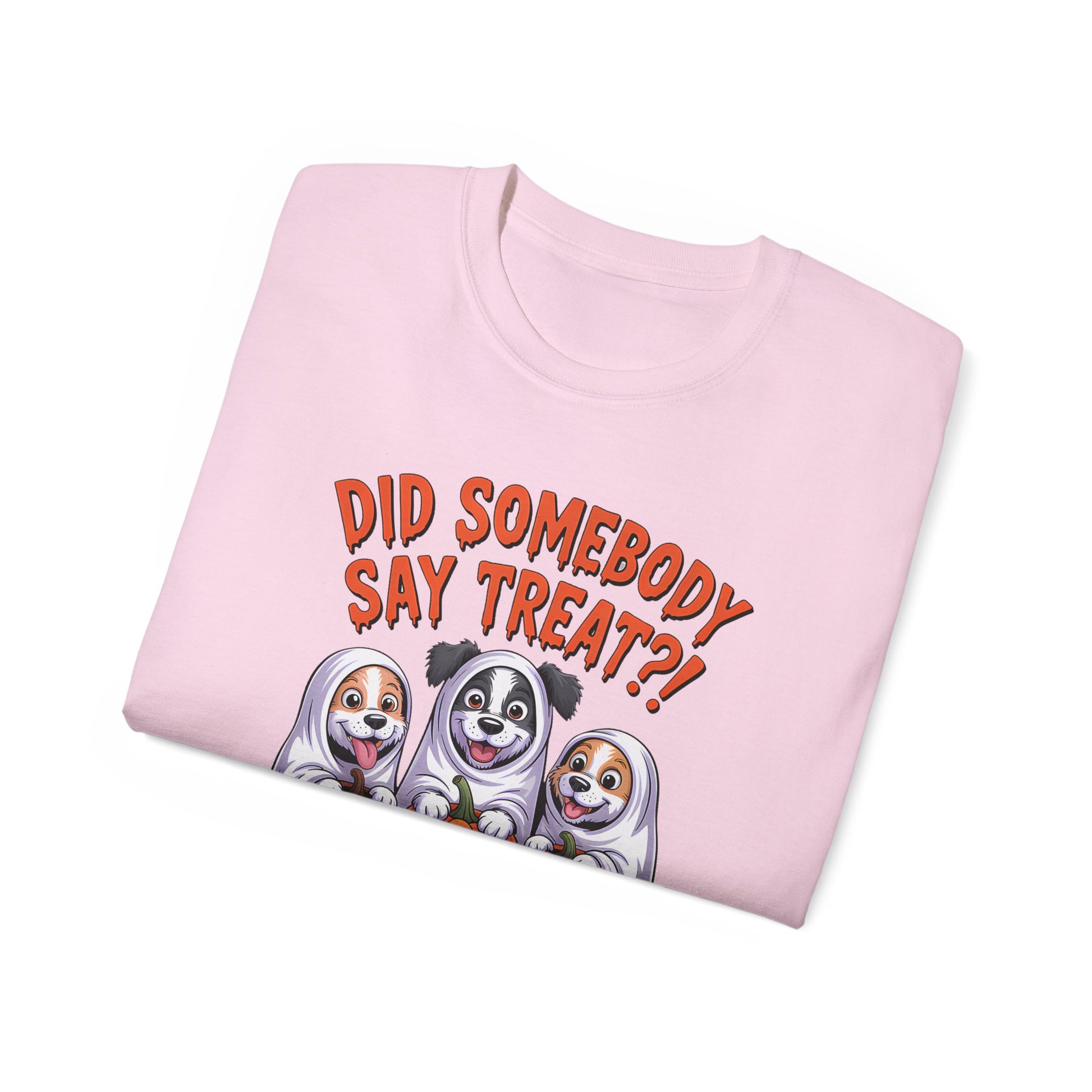 Spooky Halloween Dog Tee pink folded t shirt with three cartoon dogs in ghost costumes and treat text