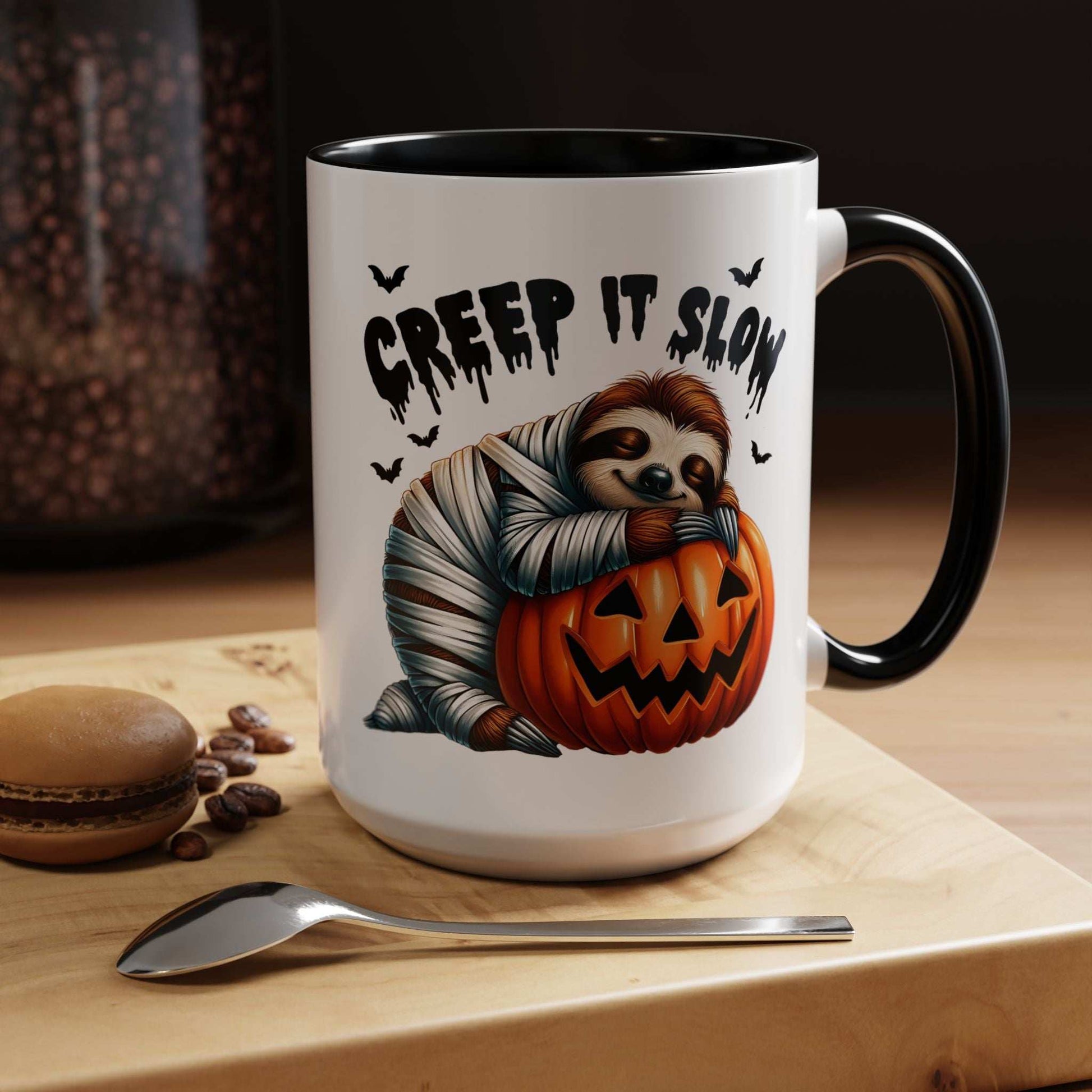 Printify Halloween Sloth Coffee Mug featuring a mummy sloth hugging a jack o lantern with Creep It Slow text and bats