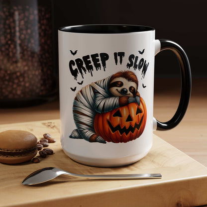 Printify Halloween Sloth Coffee Mug featuring a mummy sloth hugging a jack o lantern with Creep It Slow text and bats