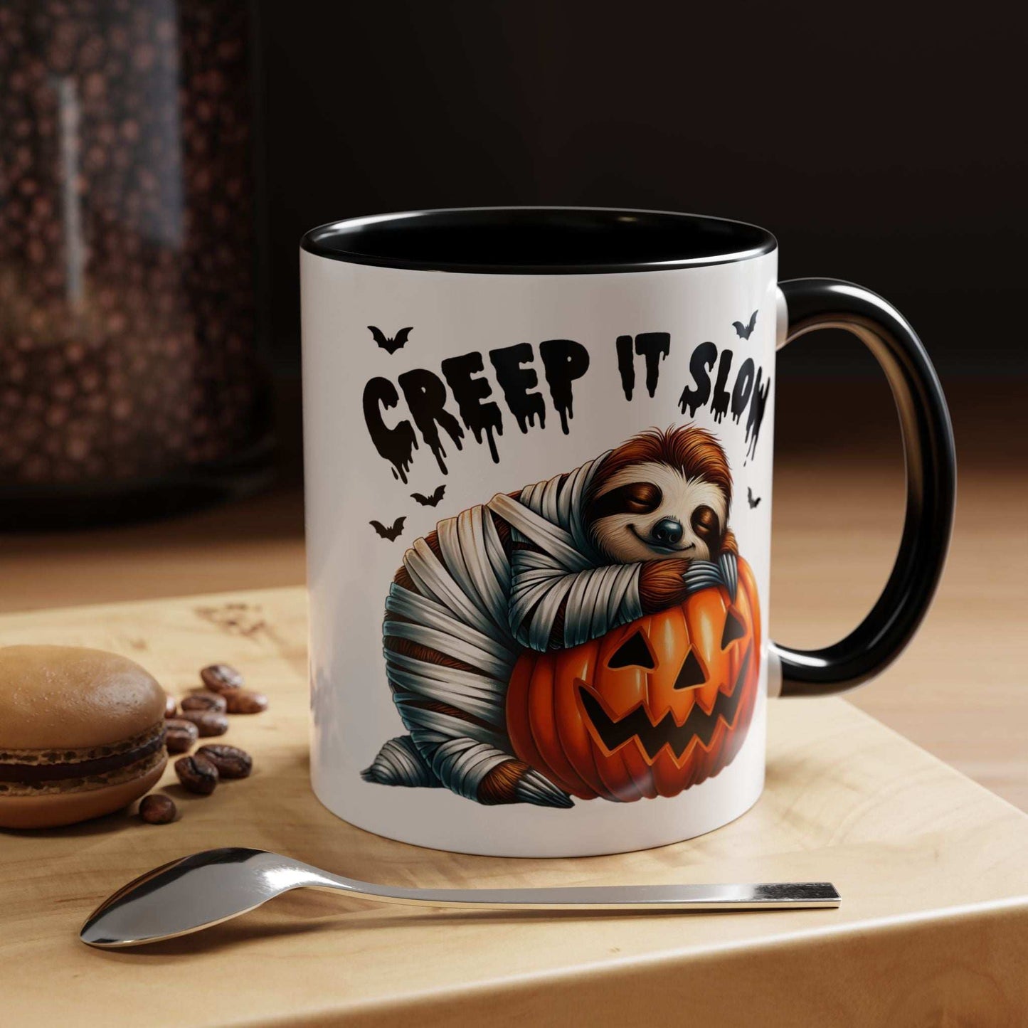 Halloween Sloth Coffee Mug white ceramic with black handle showing mummy sloth hugging jack o lantern and Creep It Slow text