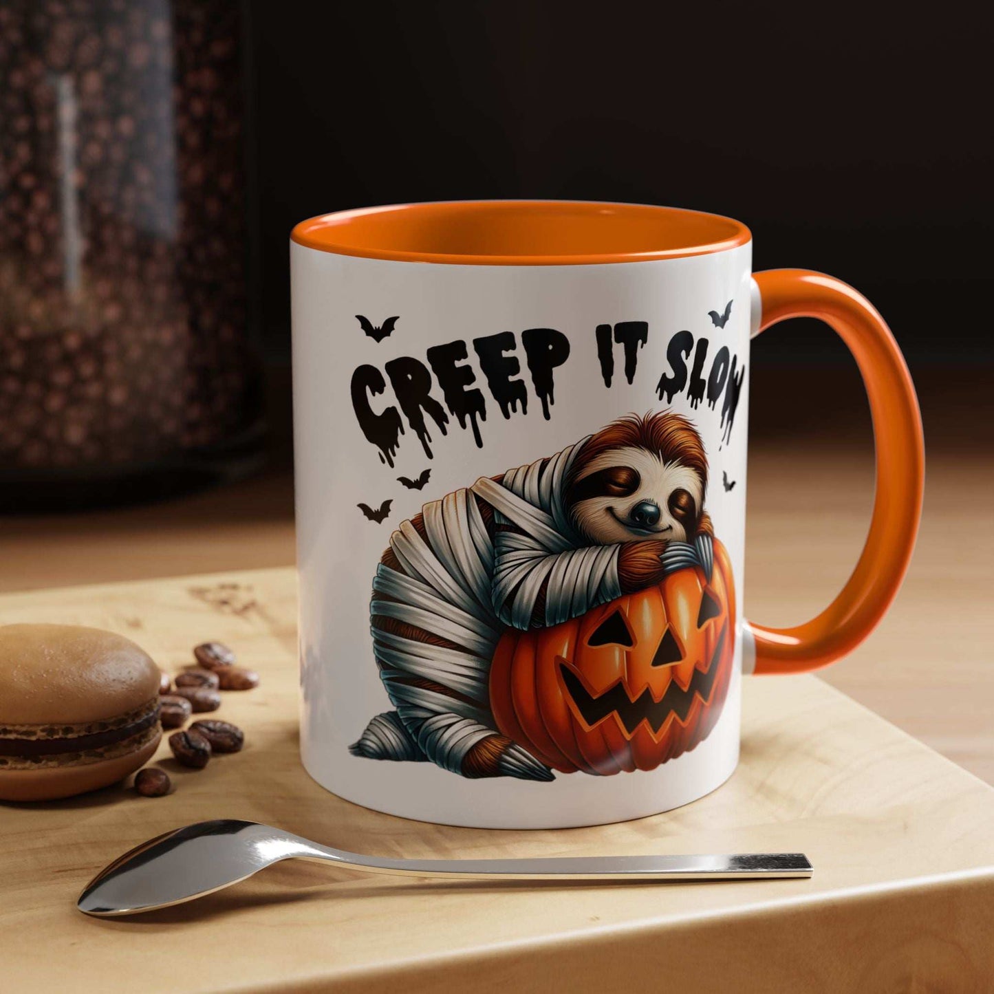 Halloween Sloth Coffee Mug featuring mummy sloth hugging jack o lantern with Creep It Slow text and orange handle