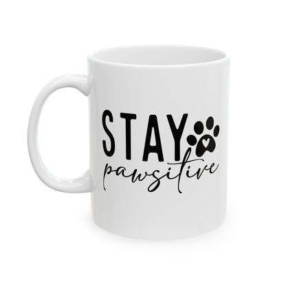 White ceramic Stay Pawsitive Mug with black text and paw print design by Printify