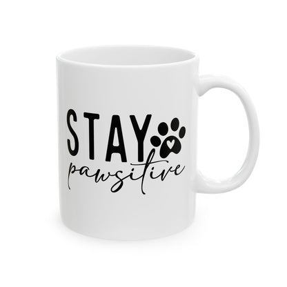 White ceramic Stay Pawsitive Mug with black text and paw print design