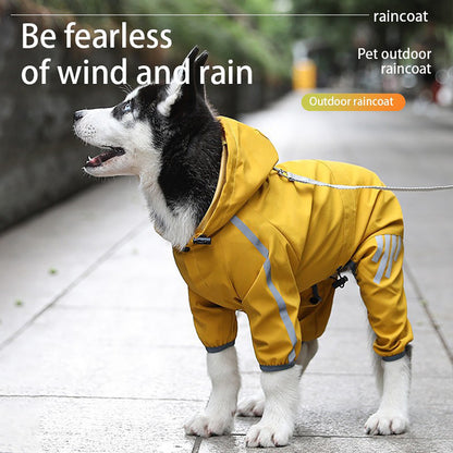 Energetic husky wearing yellow waterproof dog raincoat with hood and reflective stripes on city sidewalk