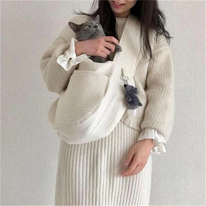 Wefulfil Cozy Pet Sling Carrier in white holding a gray cat with a plush keychain attached