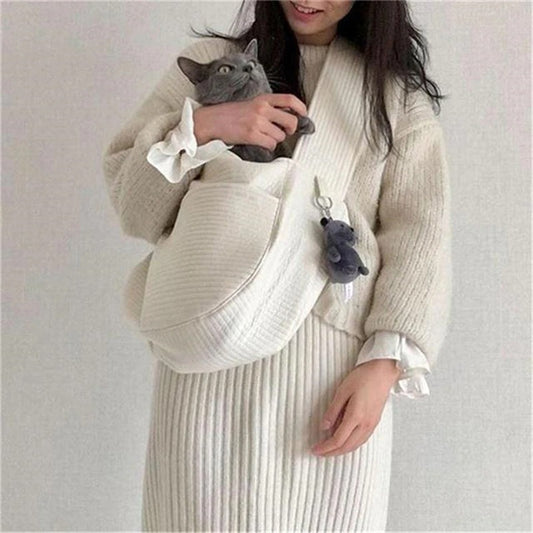 Wefulfil Cozy Pet Sling Carrier in white holding a gray cat with a plush keychain attached