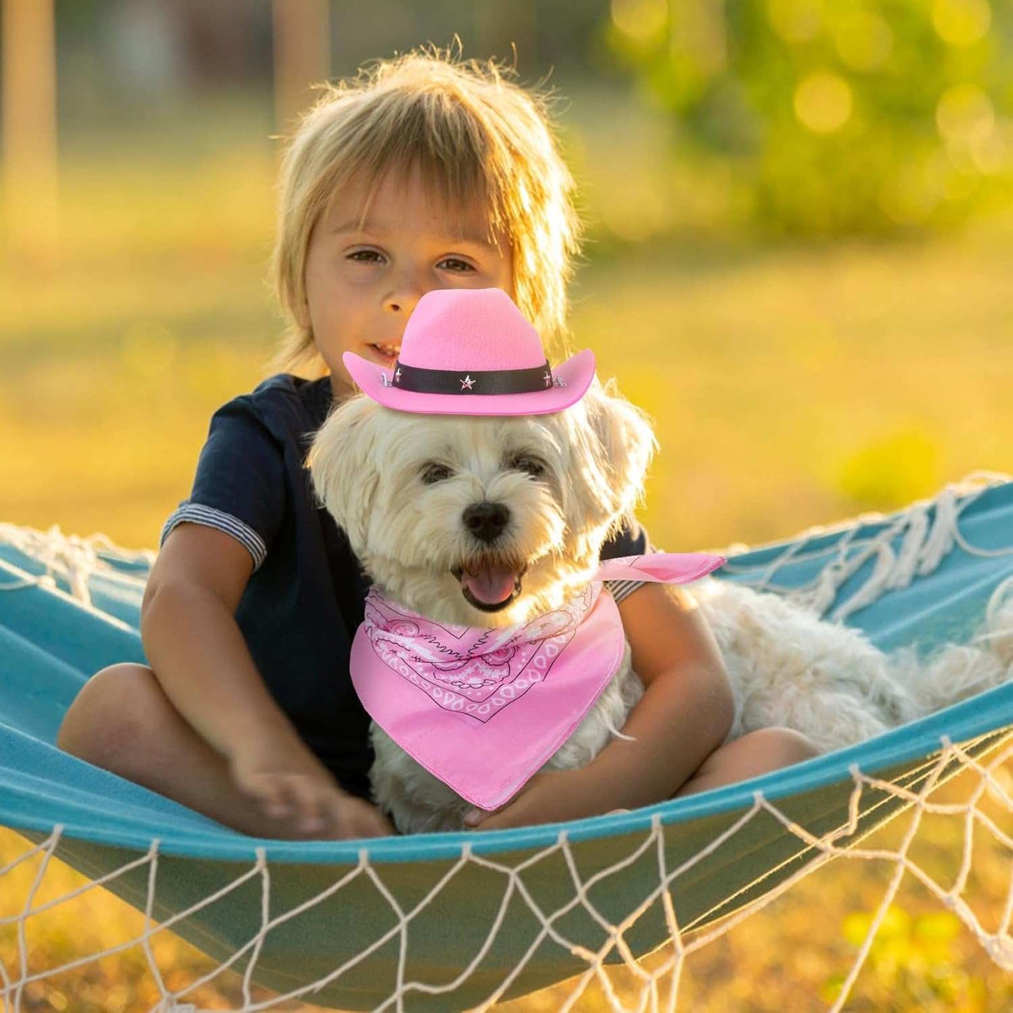 Western Bandana and Hat Set for pets featuring a pink bandana and cowboy hat on a dog with a child