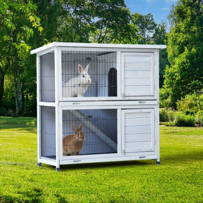 White 2-story rabbit hutch with rabbits in sunny backyard