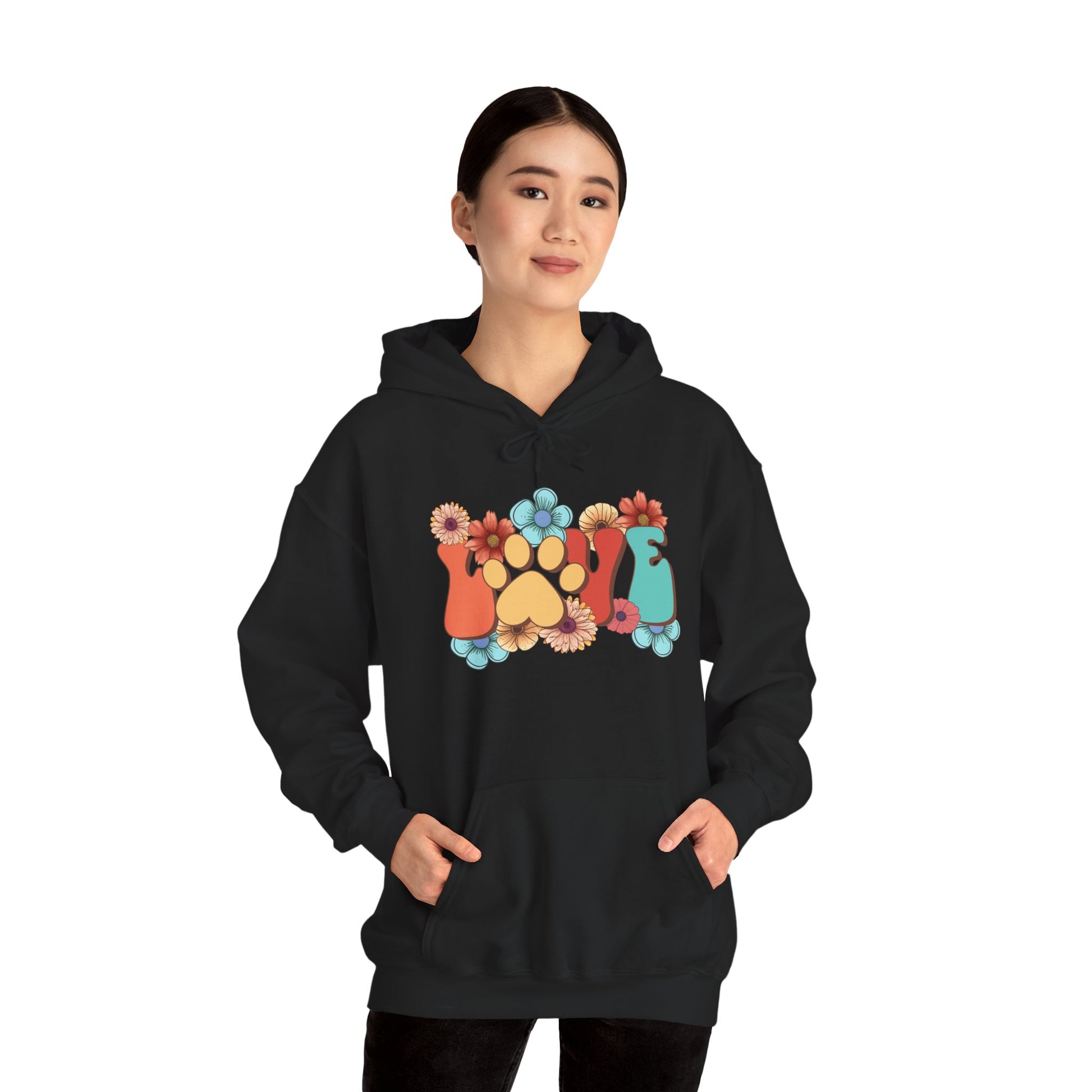 Woman wearing black Animal Lover Hoodie with colorful floral paw print and cat and dog silhouettes