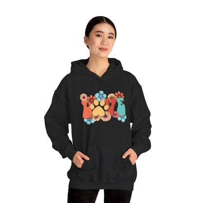 Woman wearing black Animal Lover Hoodie with colorful floral paw print and cat and dog silhouettes