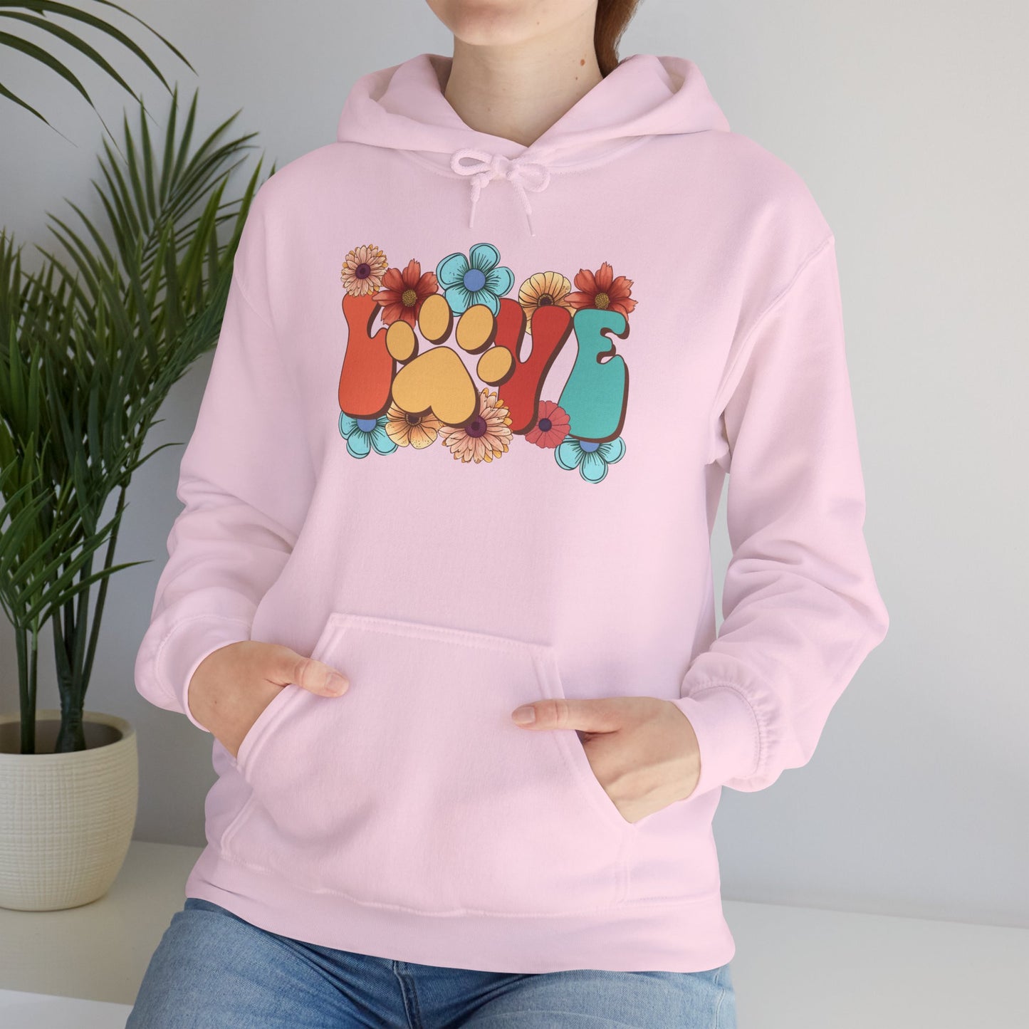 Printify pink hoodie with floral paw print LOVE graphic worn by model Animal Lover Hoodie