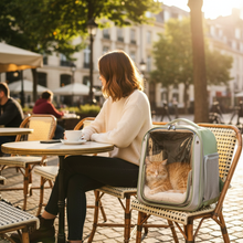 Woman at café with green cat carrier backpack
